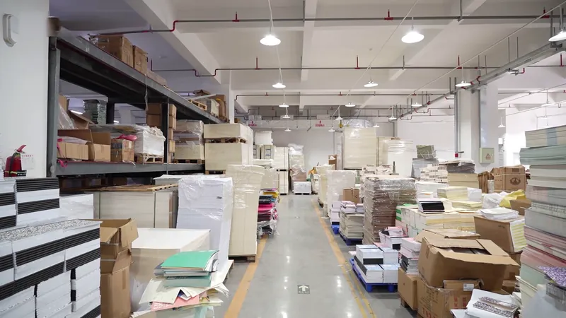 Paper stock and notebook materials stored along an aisle in our workshop