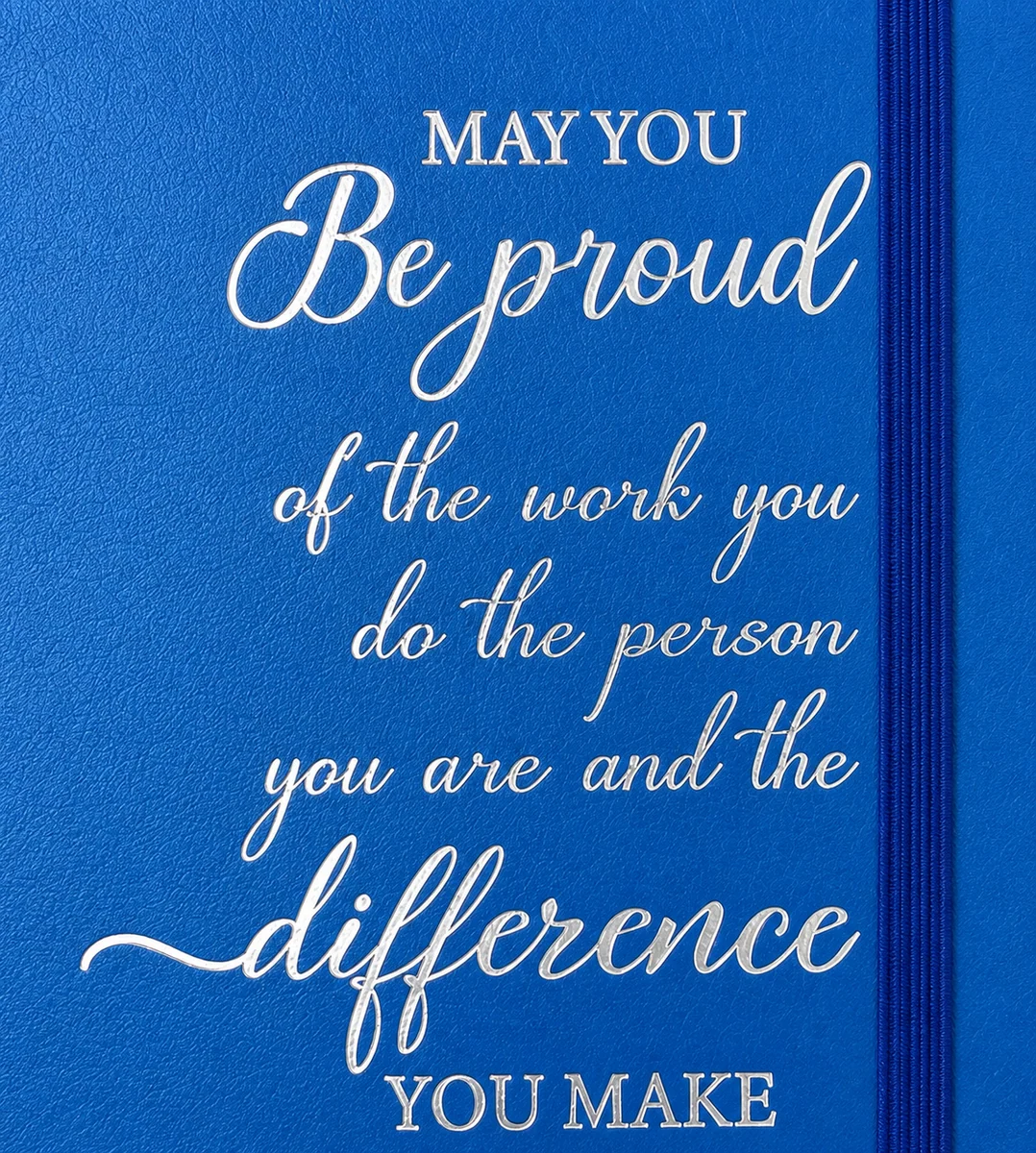 Close-up of silver foil lettering on a blue notebook cover